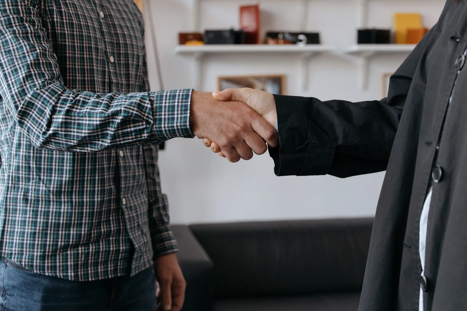 Close-up of a business handshake in a contemporary office environment.